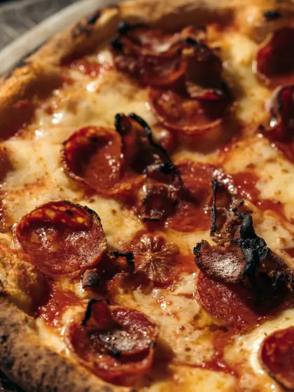 A close-up on this pepperoni and bacon pizza shows how the edges of the meat get crispy and curl up in the high heat of the oven, adding incredible texture and flavor.