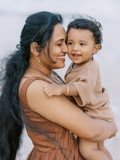 A mother and son sharing a hug on the beach. The soft light and their close bond make this a beautiful, emotional portrait.