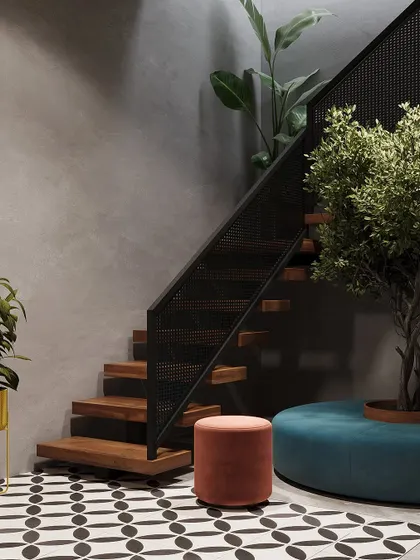 A modern staircase with wooden steps and a black perforated metal railing. The space is accented with patterned floor tiles and colorful furniture.