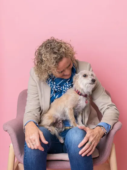 A sweet, candid moment between a woman and her dog at a pet salon launch party. Even in a busy event setting, we can find these quiet moments of connection.