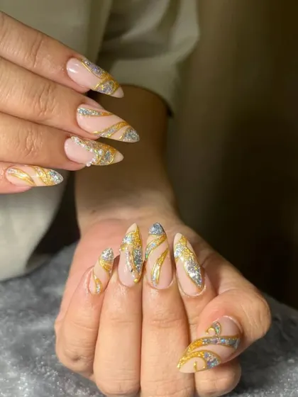 This bridal nail set is pure glamour. I used a combination of gold and silver glitter with swirling patterns over a neutral base to create a design that is both eye-catching and elegant for the big day.