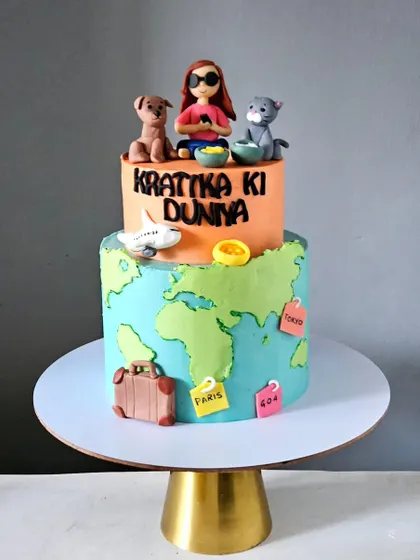 This cake, named "Krattika Ki Duniya" (Krattika's World), brings all of her favorite things together. It features a two-tiered design with a world map on the bottom and edible, handmade figurines of her with her pets on top.