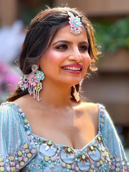 A close-up of the client's smiling face, her makeup fresh and perfect for a day event.