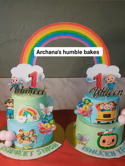 A pair of matching Cocomelon cakes for twins, Ishmeet and Ishleen. Each cake is personalized but shares the same joyful theme.