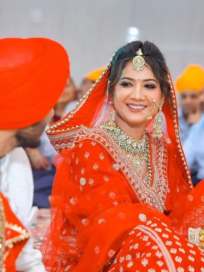 A candid moment of the bride and groom during their Anand Karaj ceremony.