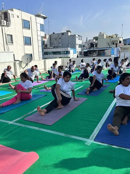 Students practicing a seated spinal twist, an important posture for improving flexibility and aiding digestion, all part of our well-rounded Hatha yoga classes.