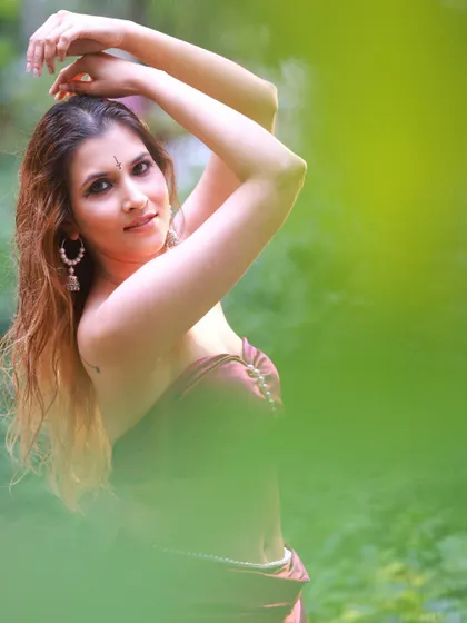 An outdoor portrait where I used the natural foliage to frame the model. This technique adds depth and a sense of mystery to the shot, focusing on her expression.