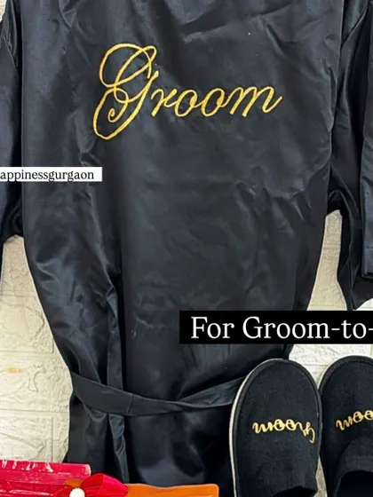 The custom-embroidered satin 'Groom' robe and matching slippers are perfect for helping the groom relax before his big day.