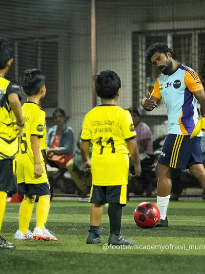 A coach demonstrates a technique to a group of young, attentive players. I believe in leading by example and showing players the right way to do things.