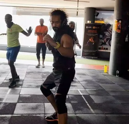 An action shot from a group class, showing members learning and practicing new moves together.