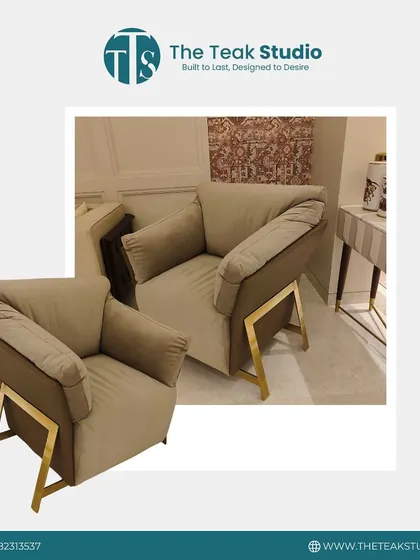A modern and plush armchair design. This piece features oversized, comfortable cushions and a unique metal frame that adds an industrial-chic touch to the design.
