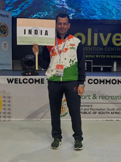 An Indian athlete holding the national flag at the Commonwealth Karate Championship in Durban. Representing India on the world stage is the highest honor for any player.