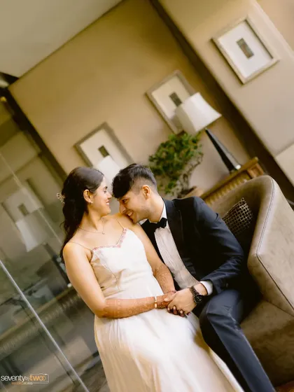 A sweet, candid moment of the couple sharing a laugh during their indoor pre-wedding shoot.