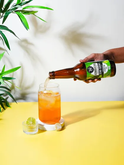 Adding a human element by showing the kombucha being poured. This action makes the product feel more engaging and ready to be enjoyed.