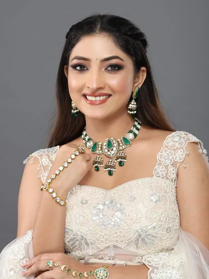 A happy, smiling portrait of the client, her makeup looking bright and radiant.
