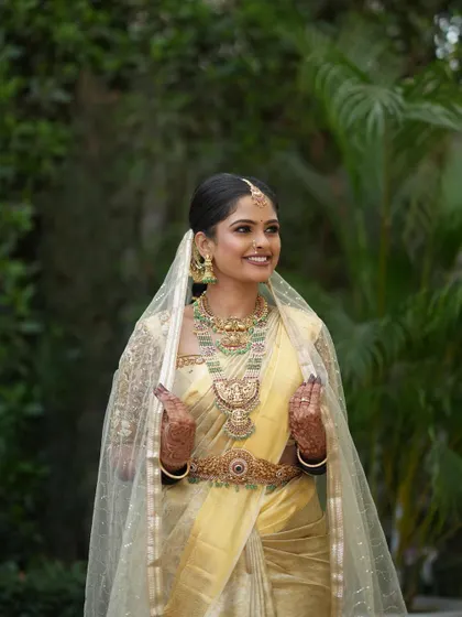 The sheer embroidered veil adds a touch of modern grace to the traditional saree.