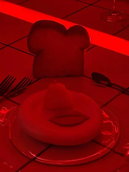 A surreal, red-lit shot of the playful butter and bread at the birthday dinner. The dramatic lighting was part of the overall mood we designed for the party.