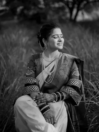 A timeless black and white portrait of the bride sitting peacefully with her eyes closed, looking absolutely radiant.