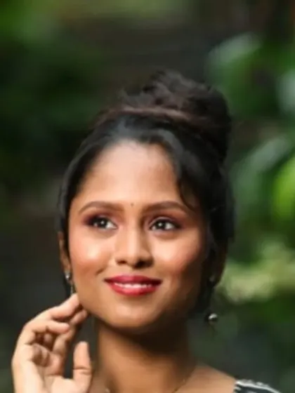 A close-up portrait from a photoshoot. I created a fresh, modern look with a simple high bun and a bright red lip that stands out beautifully.