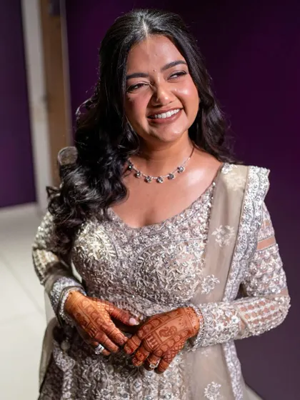 Another shot of the radiant bride. The soft waves and glowing skin create a look that is both elegant and modern.
