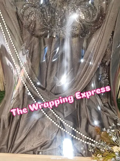 This is a heavy, stone-work gown packed with care. I make sure the draping is perfect to show off the detailed work on the bodice, and the floral decor adds a soft touch.
