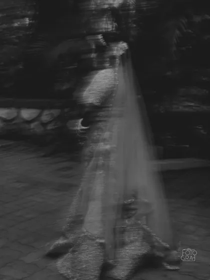 An artistic, motion-blur black and white portrait of the bride, creating a ghostly and ethereal effect that is both mysterious and beautiful.