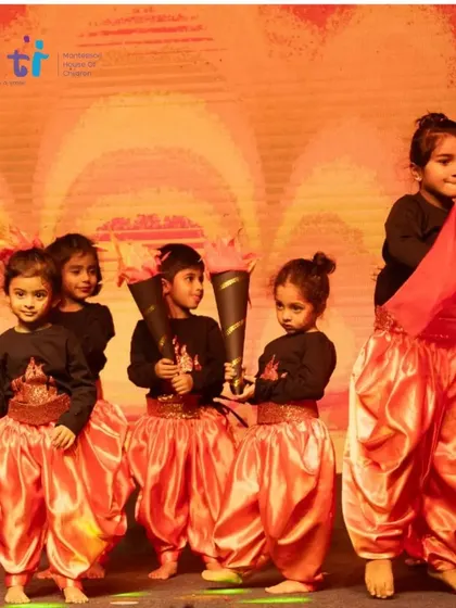 A group of our youngest performers dressed as fire, holding their torch props with pride.