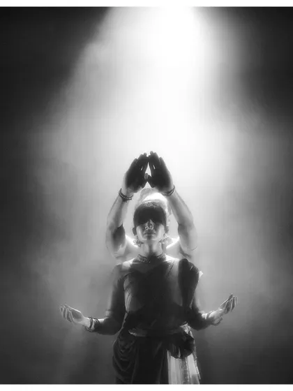 A creative black and white shot from 'Naga Mandala', where the dancers' forms merge to create a single, powerful entity.