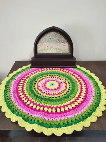 Here, the Viola mandala is used as a decorative mat on a side table. It adds a wonderful pop of color and handmade charm to the room.