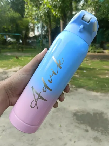 A beautiful dual-tone steel bottle engraved with the name 'Advik.' The color gradient from pink to blue makes it very eye-catching.