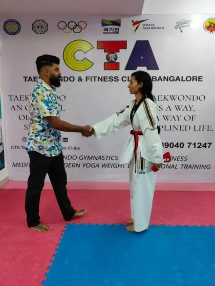 A handshake for a new red belt.
