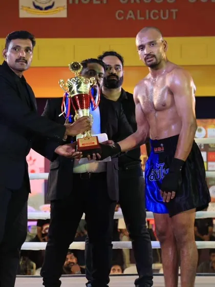 Another shot of our fighter Edukondal Rao with his well deserved trophy after a grueling Muay Thai battle.