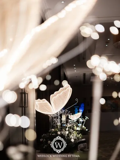 An enchanted forest Sangeet night, where the ceiling was a canopy of lush greenery dotted with sparkling disco balls and glowing LED butterflies. This immersive decor created a magical atmosphere for dancing.