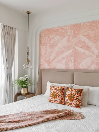 The beautiful 'after' of our Project Lily bedroom. This image showcases the final design with a soft pink accent wall, a custom bed, and carefully selected decor that creates a dreamy and serene atmosphere.