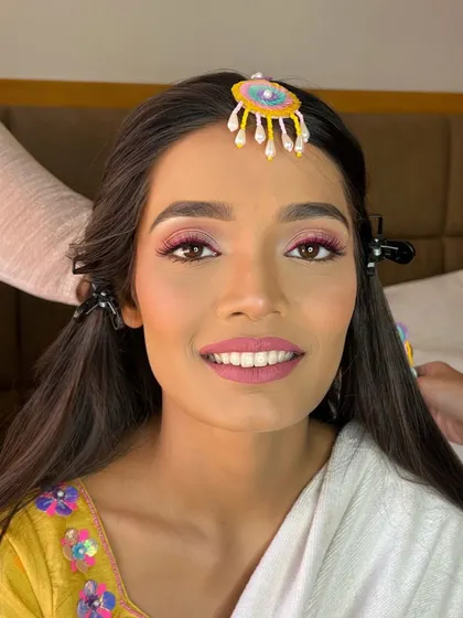 A smiling close-up of the bride, her makeup looking fresh and flawless.
