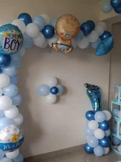 A close-up of the baby boy themed balloon arch and 'BABY' blocks, showing the cute foil balloon details.