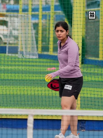 A female player gets ready to serve during a match. We welcome players of all genders and skill levels to compete in our events.