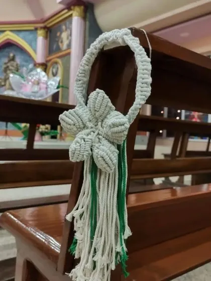 Another view of the single-flower pew hanger, showing how it adds a simple, elegant touch to the wedding decor.
