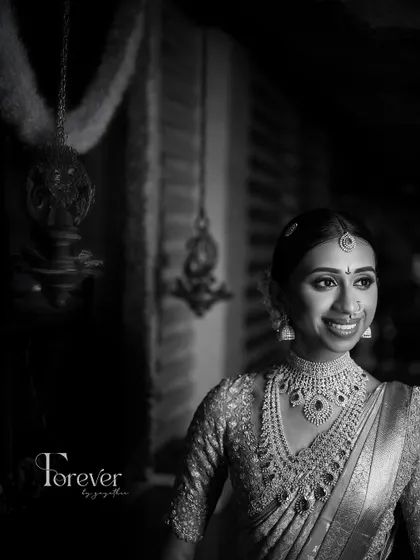 A classic black and white portrait of the bride. This timeless style highlights the flawless makeup application and the sparkle of her diamond jewellery.
