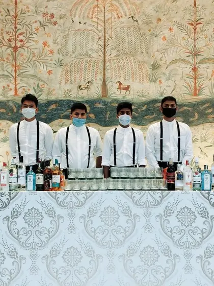 This bar features a beautiful damask pattern front, blending perfectly with the elegant decor of a wedding reception. Our team stands ready and masked, ensuring safe and professional service throughout the event.