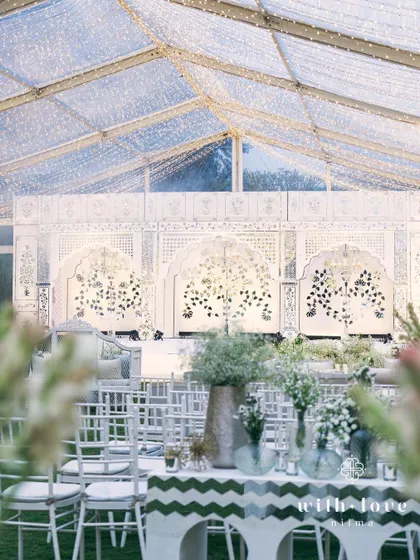 The Thikri stage seen through a frame of greenery, highlighting the contrast between nature and craftsmanship.