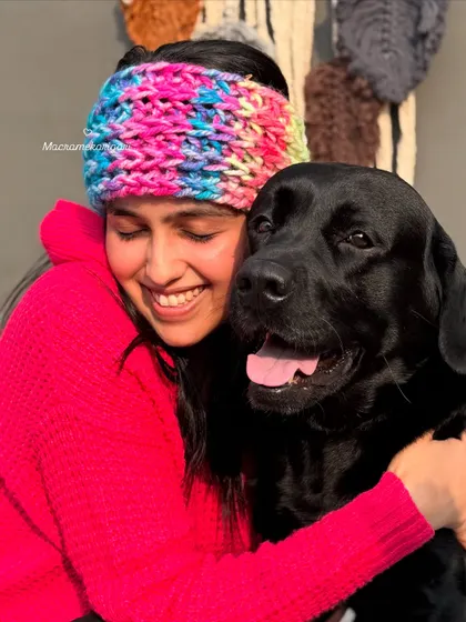 Nothing makes us happier than seeing our creations loved, especially by our furry friends. Here I am wearing one of our cozy, multi-colored winter headbands, perfect for keeping your ears warm in style.