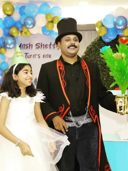 A magical bouquet of flowers appears, and the birthday girl's smile says it all. I use bright, colorful props to keep the show visually exciting for children.