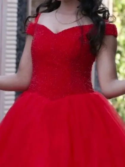 A close up of the beaded bodice on our red ball gown, adding a touch of sparkle.
