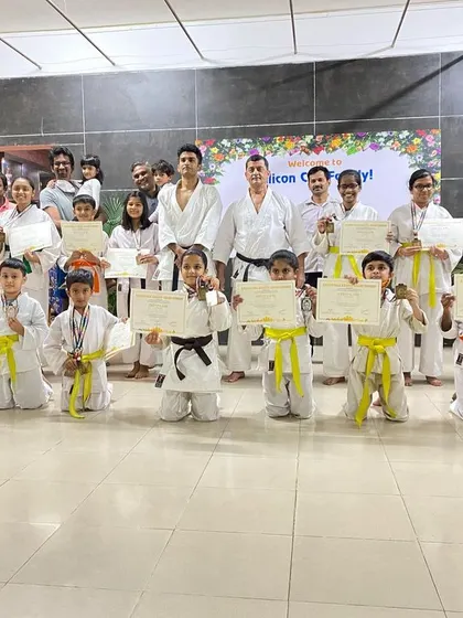 Medal winners from our Silicon City dojo, joined by their parents, celebrating their success at a recent tournament.