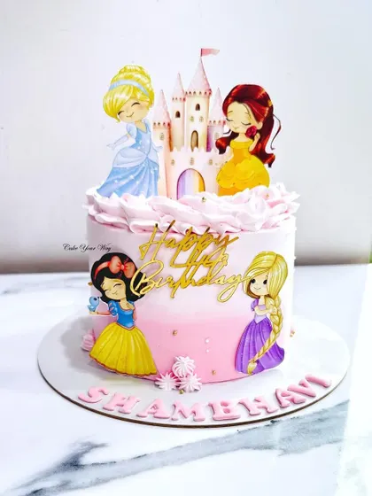A fairytale cake featuring four classic Disney princesses. The pink ombre frosting and castle topper make it a dream come true for any little princess.