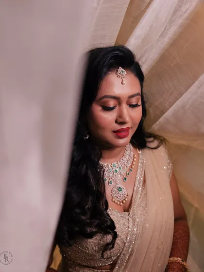 A soft and dreamy bridal portrait. The sheer curtain diffuses the light beautifully, creating a gentle glow around the bride and her stunning diamond necklace.