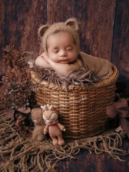 Baby's day out. This rustic setup with a wicker basket and tiny stuffed animals has a classic, timeless feel.
