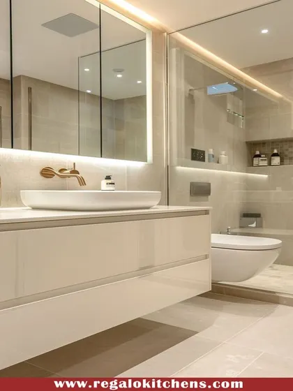 A high-gloss white floating vanity creates a clean and spacious feel in this bathroom. The large, backlit mirror provides excellent lighting for daily routines.
