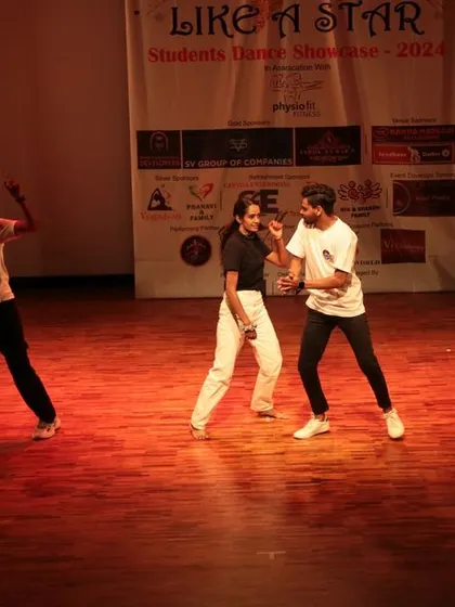 A moment of interaction between dancers as part of their choreographed story.